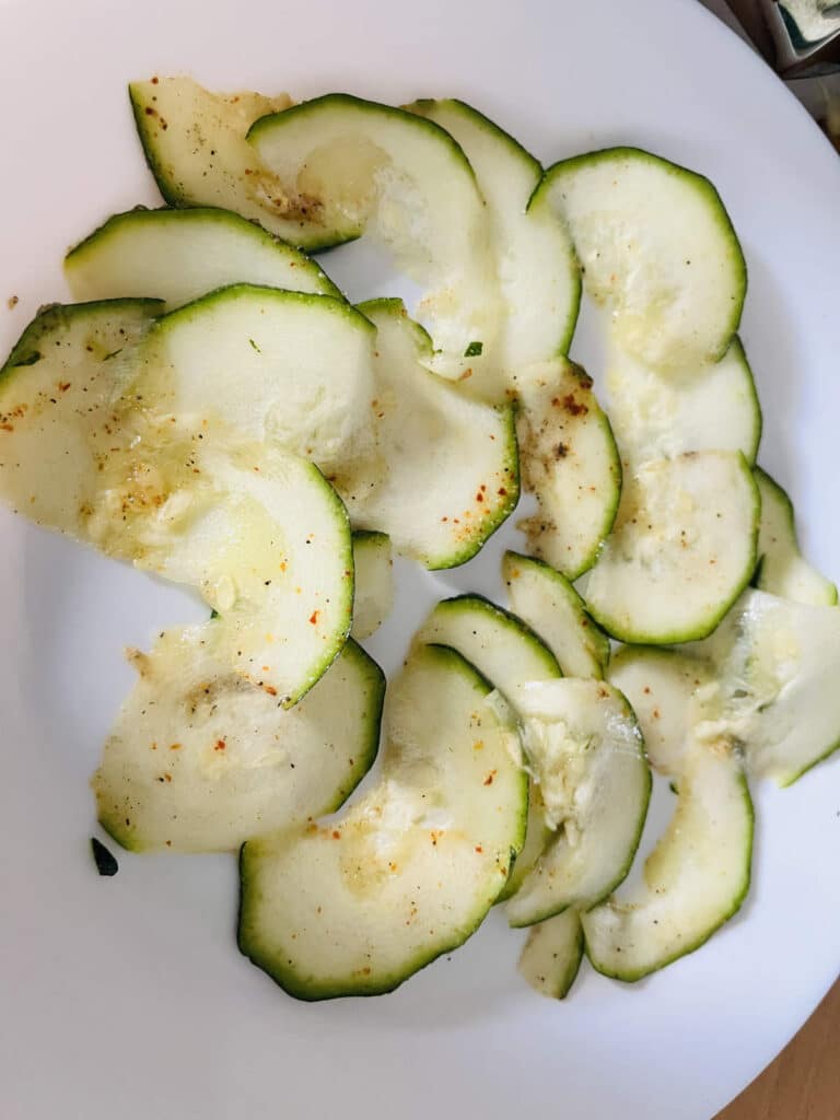 Spiced zucchini chips before placing in the air fryer