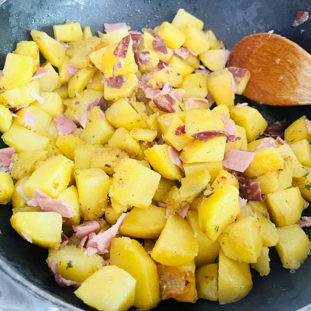 Potato and ham cooking before the eggs are added