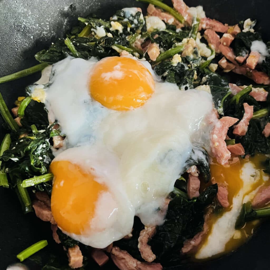 Egg added to the spinach and bacon