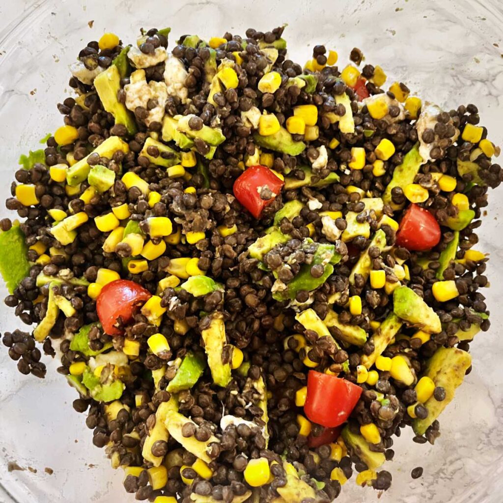 Avocado lentil salad mixed with dressing