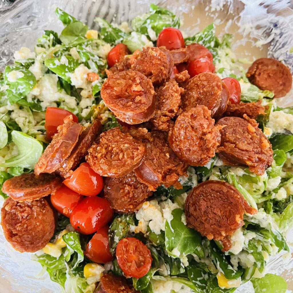 Chorizo and tomatoes going into the salad