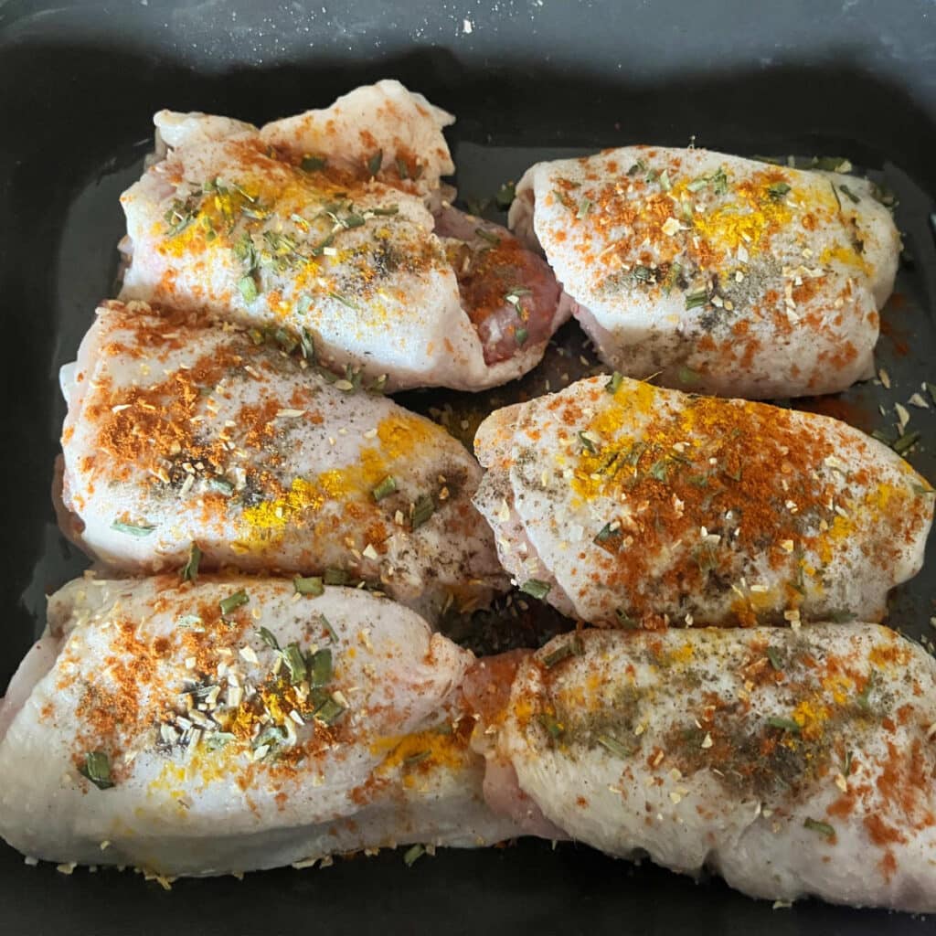 chicken thighs with spices rubbed on it