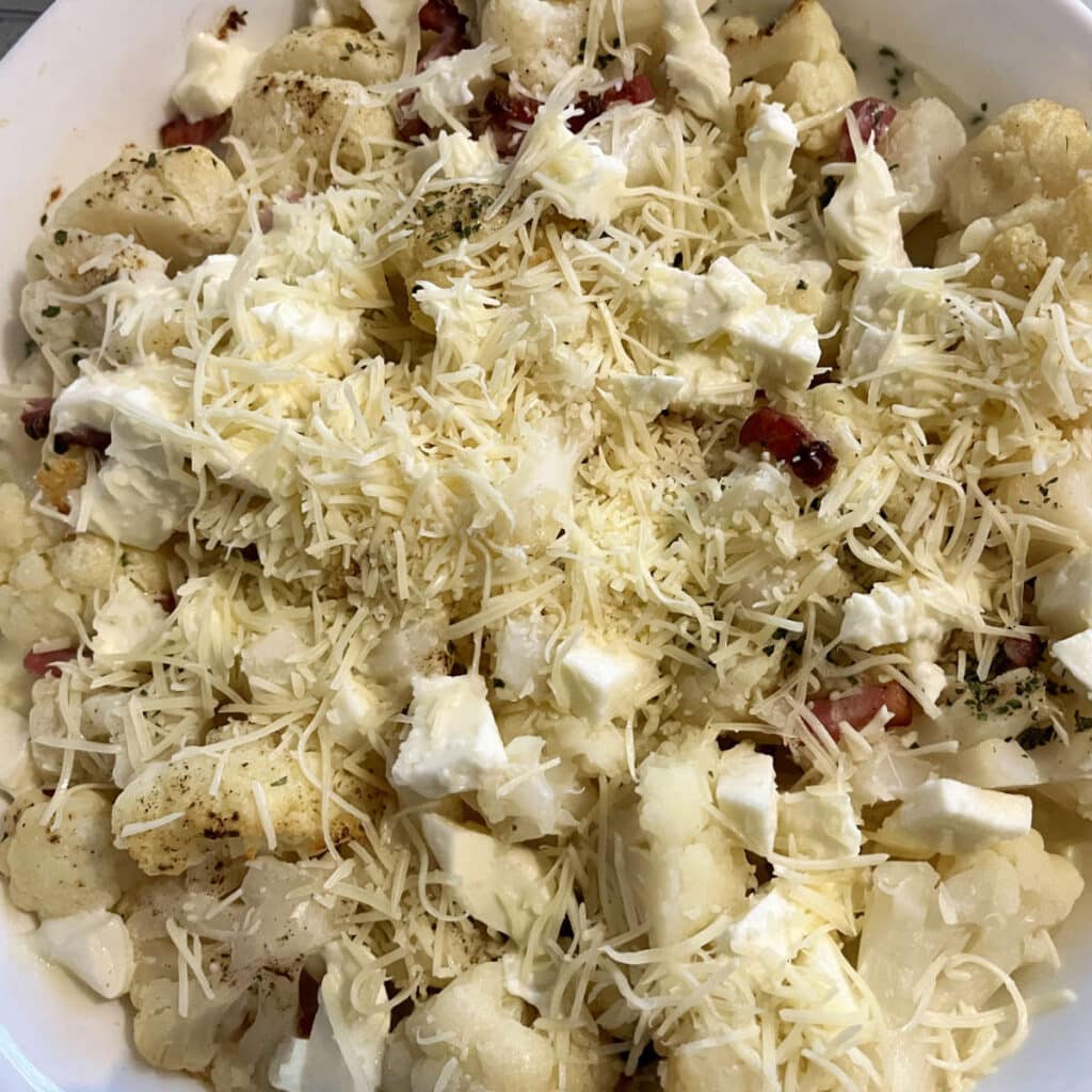 Grated cheese and mozzarella added to the top of the cauliflower gratin