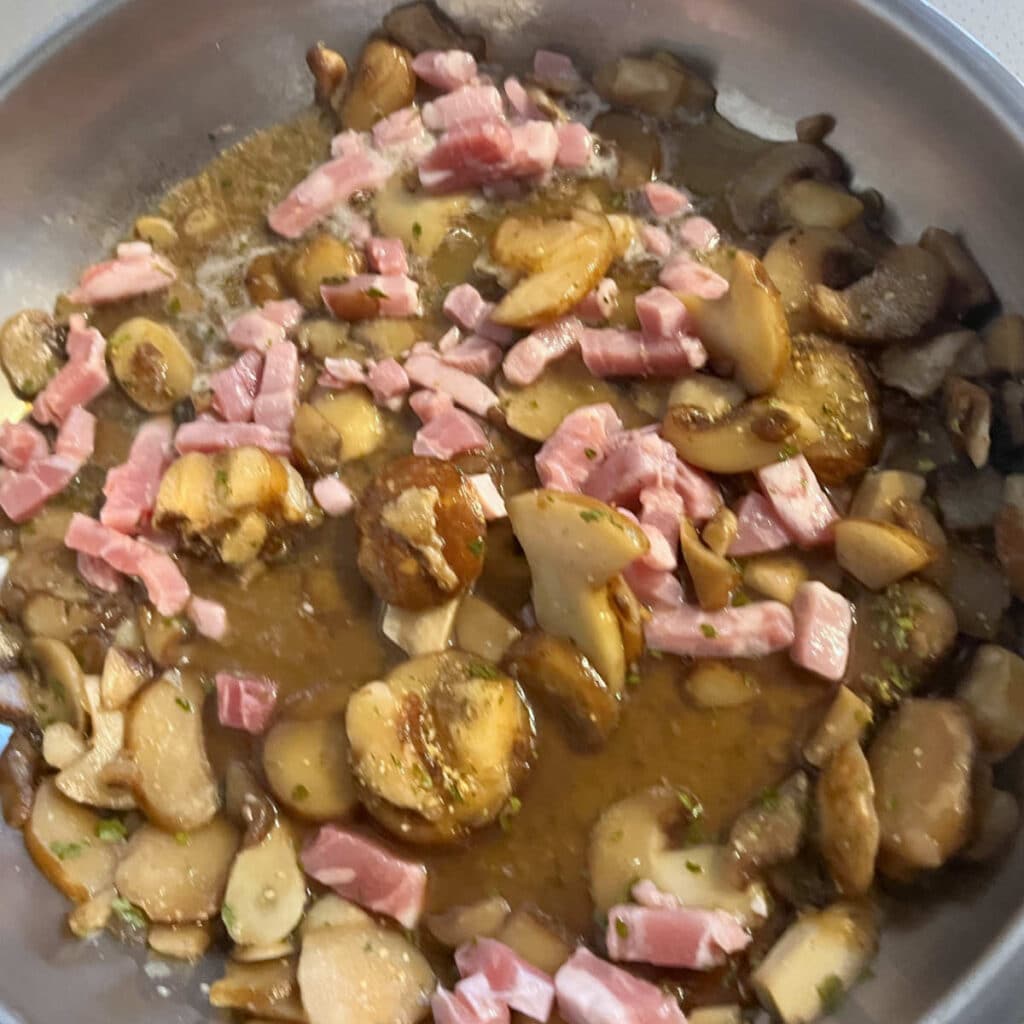 Cooking the mushrooms and pieces of bacon