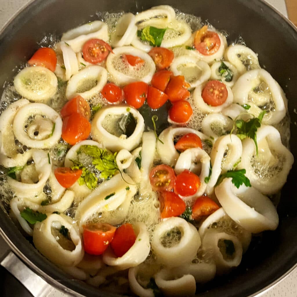 cherry tomatoes cooking with the calamari