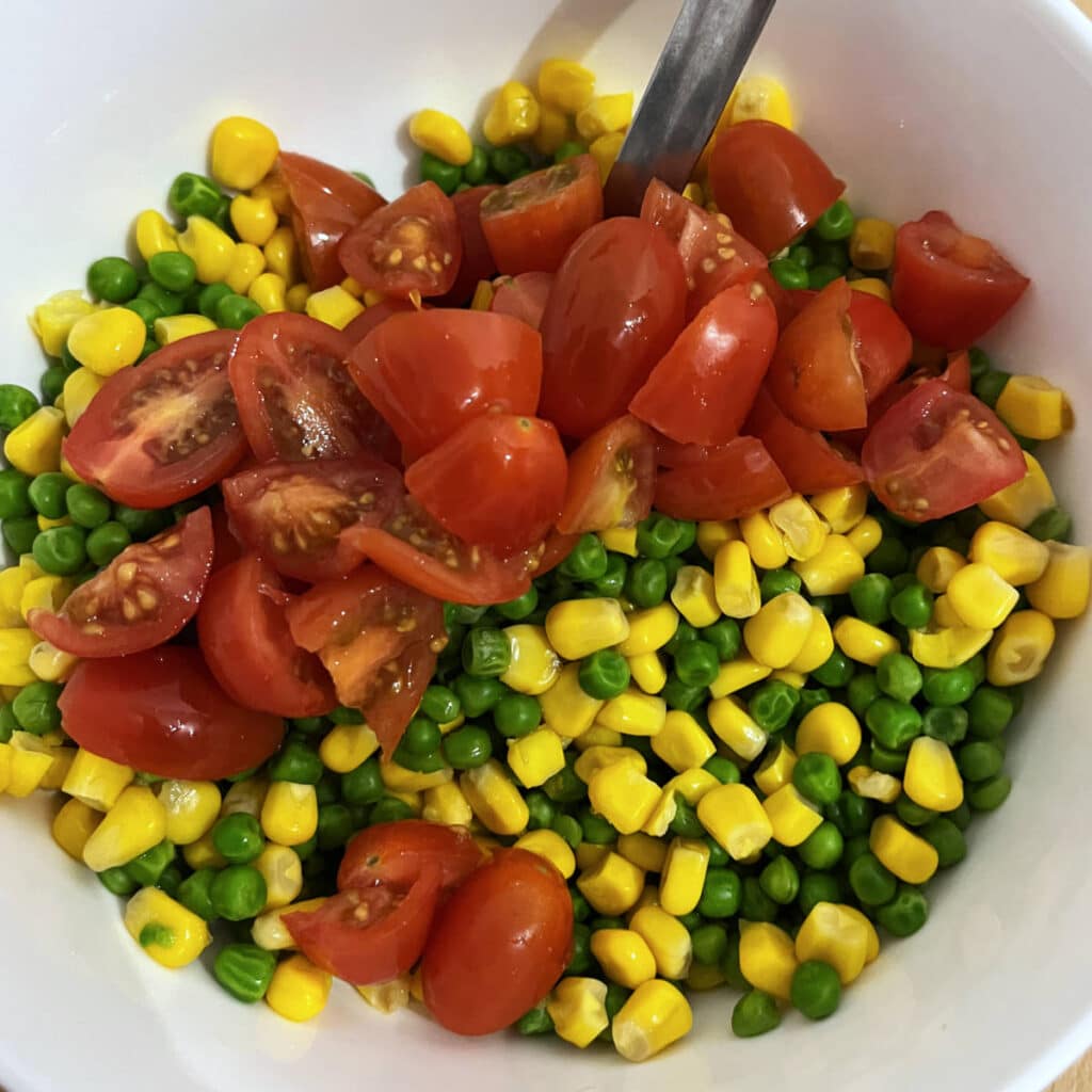 Cherry tomatoes added to the peas and corn