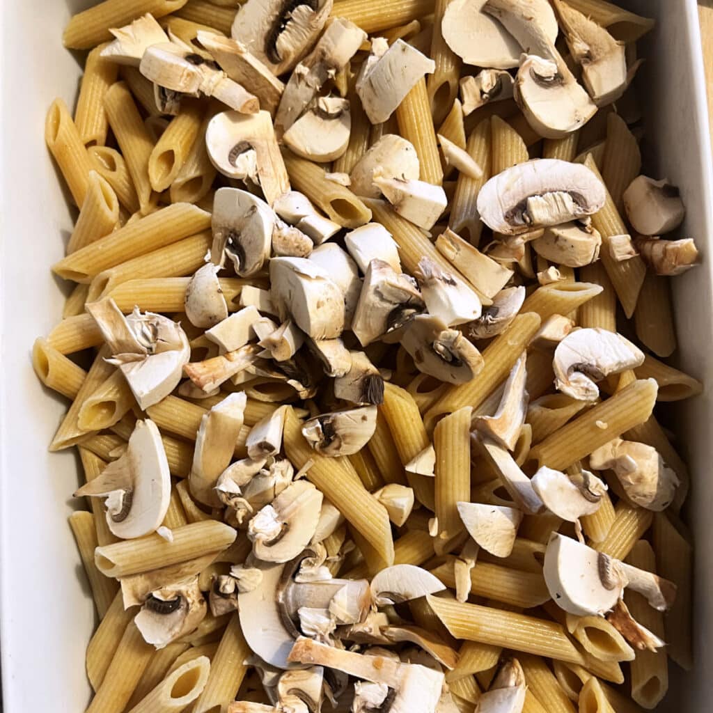 Adding mushrooms to the pasta bake